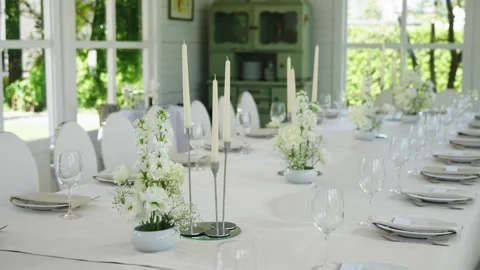 Elegant wedding reception table setting with floral arrangements and candles Stock Footage 339458903
