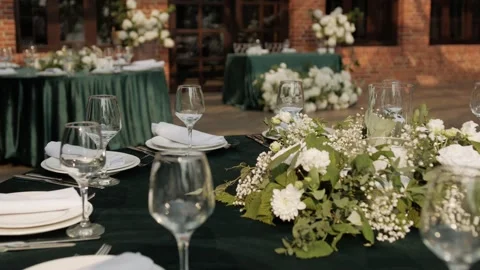 Elegant wedding reception table settings with floral decorations and glassware Видео 338069790