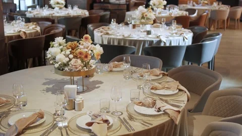 Elegant wedding reception table setup with floral centerpieces and fine dining Видео 338070194