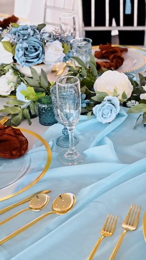 Elegant wedding table decor with blue runner and gold. Detailed view of formal Stock Footage 329511564