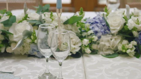 Elegant wedding table runner with glasses, flowers, and invitation Stock Footage 309613153
