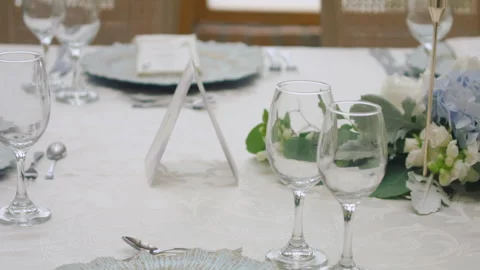 Elegant wedding table runner with glasses, flowers, and invitation Stock Footage 309618325