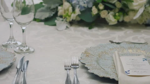 Elegant wedding table runner with glasses, flowers, and invitation Stock Footage 309618335