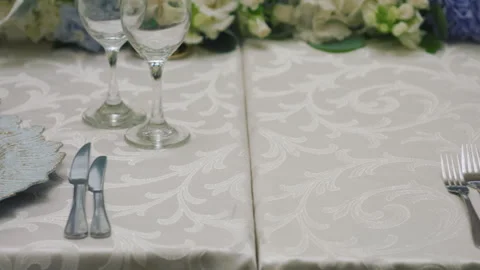 Elegant wedding table runner with glasses, flowers, and invitation Stock Footage 309618547