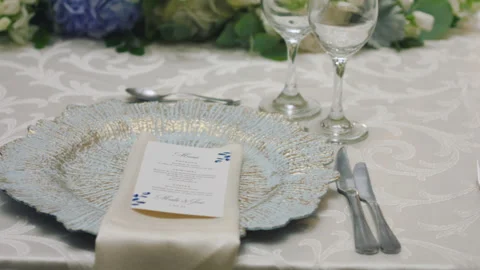 Elegant wedding table runner with glasses, flowers, and invitation Stock Footage 309618610