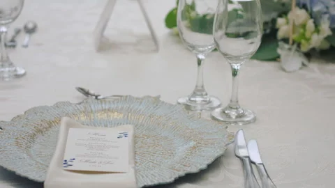 Elegant wedding table runner with glasses, flowers, and invitation Stock Footage 309618669