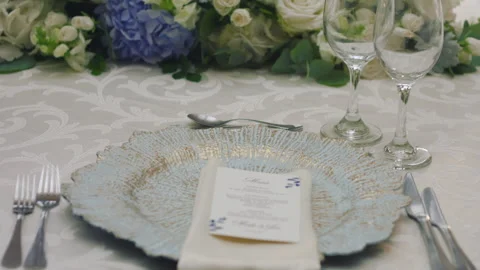 Elegant wedding table runner with glasses, flowers, and invitation Stock Footage 309618841