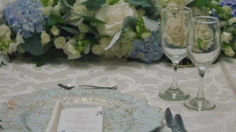 Elegant wedding table runner with glasses, flowers, and invitation Stock Footage 309618879