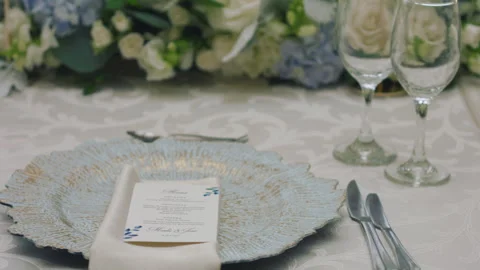 Elegant wedding table runner with glasses, flowers, and invitation Stock Footage 309619086