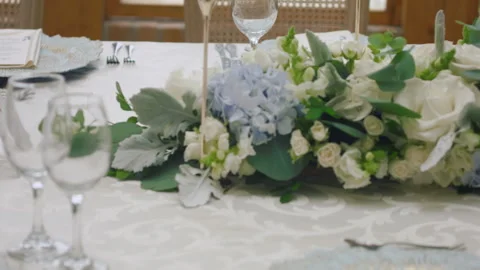 Elegant wedding table runner with glasses, flowers, and invitation Stock Footage 309619109