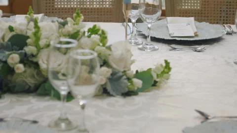 Elegant wedding table runner with glasses, flowers, and invitation Stock Footage 309619152