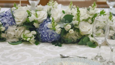 Elegant wedding table runner with glasses, flowers, and invitation Stock Footage 309619176