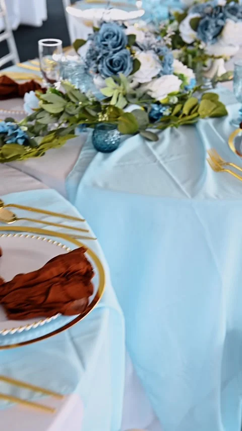 Elegant wedding table setting with blue and gold decor. Top view of a formal Stock Footage 329511421