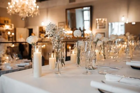Elegant Wedding Table Setting with Candles and Flowers Stock Photos