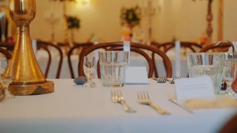 Elegant Wedding Table Setting Featuring Golden Decor in Banquet Hall Stock Footage 342018870