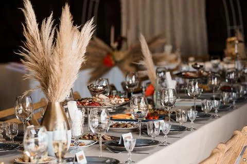 Elegant Wedding Table Setting with Pampas Grass Decor, Warm Tones, Fine Dining Stock Photos