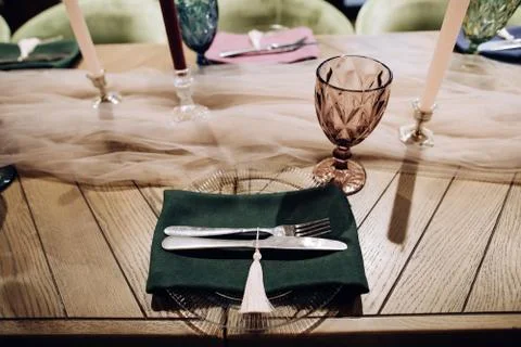 Elegant wedding table setting with silver fork and knife on green cloth Stock Photos