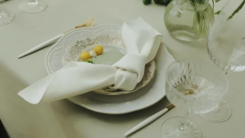 Elegant wedding table setting with white plates, glasses and floral accents Stock Footage 306150369