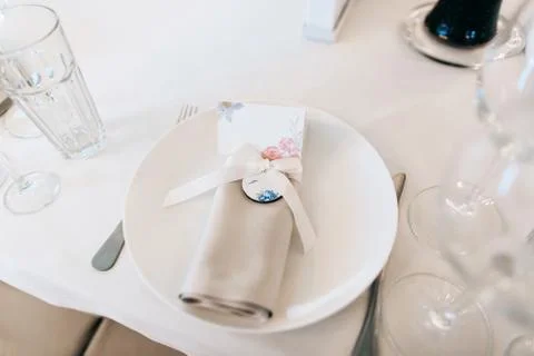 Elegant wedding table setting in white with silverware Stock Photos