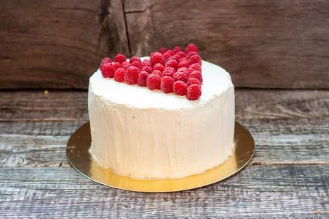Elegant white cake with raspberry heart for St. Valentine's Day, Mother's D.. Stock Photos