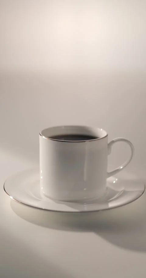 Elegant White Coffee Cup and Saucer on a White Table Stock Footage 337048878