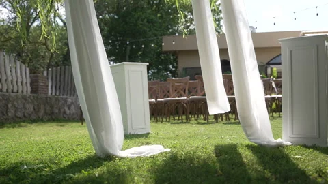 Elegant white drapes for a wedding ceremony blowing in the wind Stock Footage 340201743