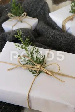 Elegant white handcraft gift boxes and fresh fir branches, seasonal celebrati Stock Photos