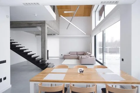 Elegant white kitchen interior with a large panoramic window without people Stock Photos