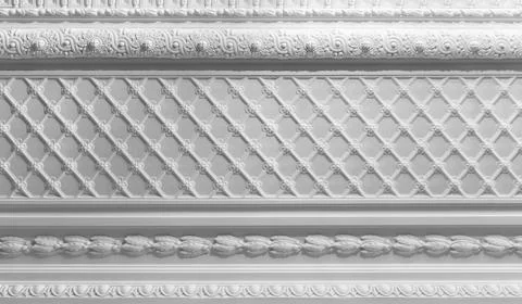 Elegant white plaster ceiling molding featuring a repeating lattice pattern Stock Photos