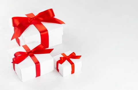 Elegant white present boxes different size with red ribbon on wood table, top Stock Photos