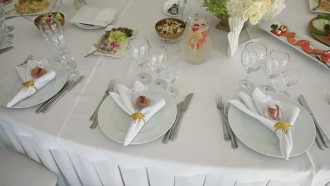 Elegant White Table Setting With Gourmet Appetizers and Floral Decor for Event Stock Footage 343848592