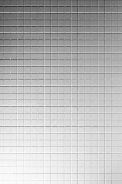 Elegant white tiny square ceramic tiles as texture, background with grey ligh 写真素材