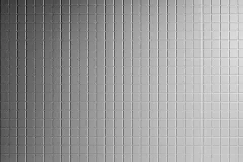 Elegant white tiny square ceramic tiles as texture, background with grey ligh Stock Photos