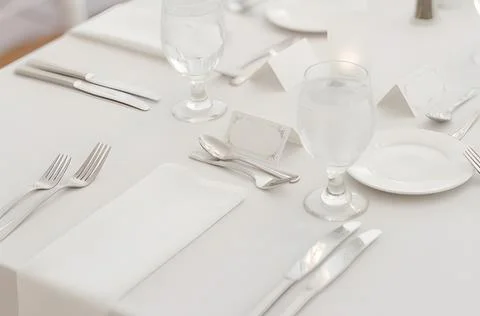 Elegant white wedding table setting with formal place cards Stock Photos