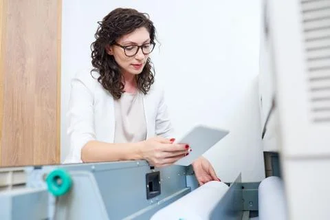 Elegant woman checking plotter Stock Photos