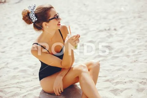 Elegant woman in a sunny beach Stock Photos