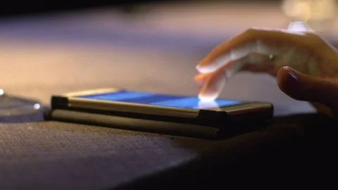 Elegant woman's hand using smartphone on the table Stock Footage 92767858
