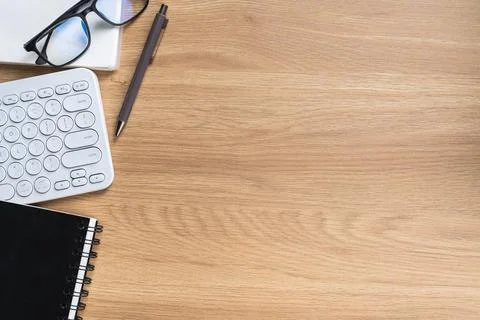 Elegant Workspace with Computer Keyboard, Notebook, Pen, Glasses, and Lapto.. Stock Photos