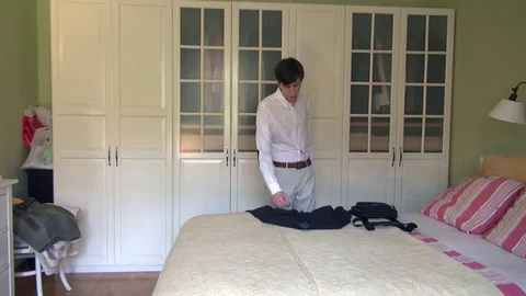 Elegant young businessman getting dressed in a suit for work Stock Footage 80376834