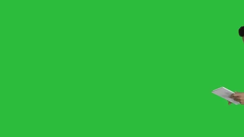 Elegant young businessman using tablet while walking on a Green Screen, Chroma Stock Footage 109071185