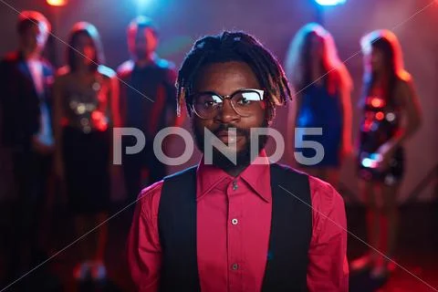 Elegant young man of African ethnicity looking at camera at party Stock Photos