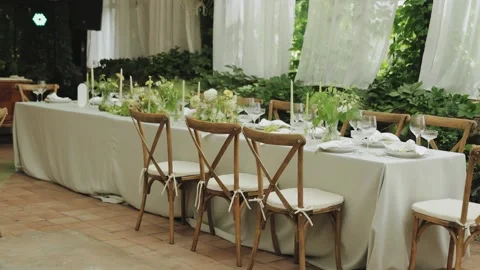 An elegantly decorated dining table at a wedding, decorated with flowers Video stock 306150962