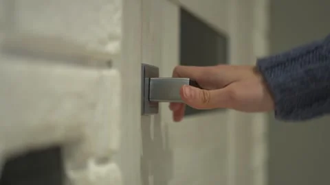 Elegantly opening a modern door handle with grace and sophistication for your Stock Footage 318544634