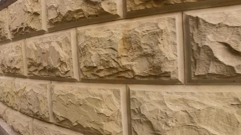 Element of architecture facade of a wall made of decorative beige stone. Stock Footage 91682854