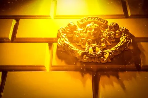 Element of architecture on the wall under the warm light of the lantern in winte Stock Photos