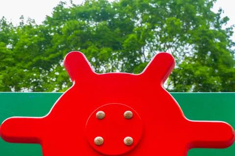 An element of a children's swing. steering wheel . An outdoor colorful playgr Stock Photos