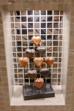 An element of decor in the form of many stylized hearts stands on a shelf. Stock Photos