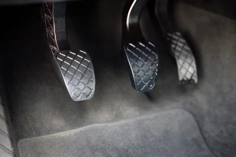 Element of modern luxury car interior metal gas clutch and brake pedal. Sport Stock Photos