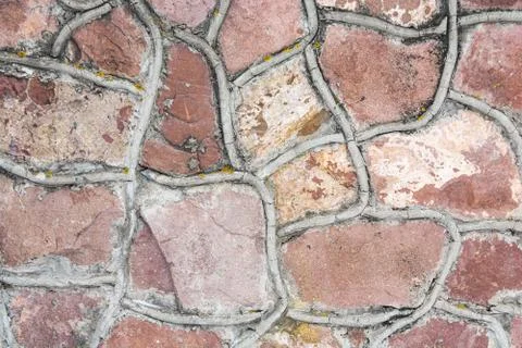 Element of street cladding of a building or structure with natural rough ston Stock Photos