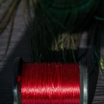 Element of thread on a spool close-up. Materials and tools for tying baits on Stock Photos